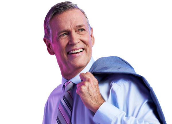 Man wearing business attire and carrying a suit jacket over his shoulder with a blue background.